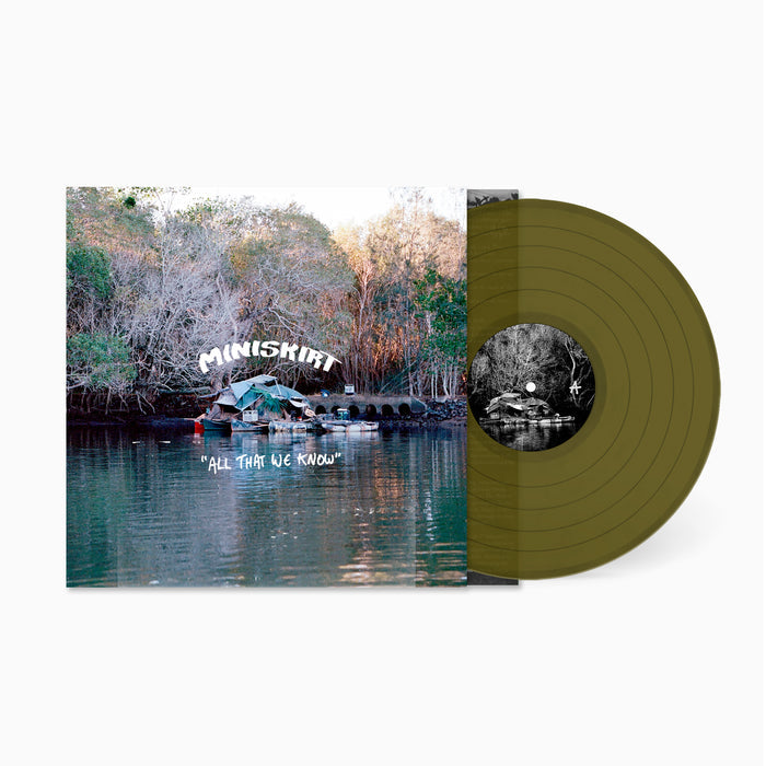 Vinyl record with a scenic cover featuring a lake and trees, displaying the album 'All That We Know' by Miniskirt.